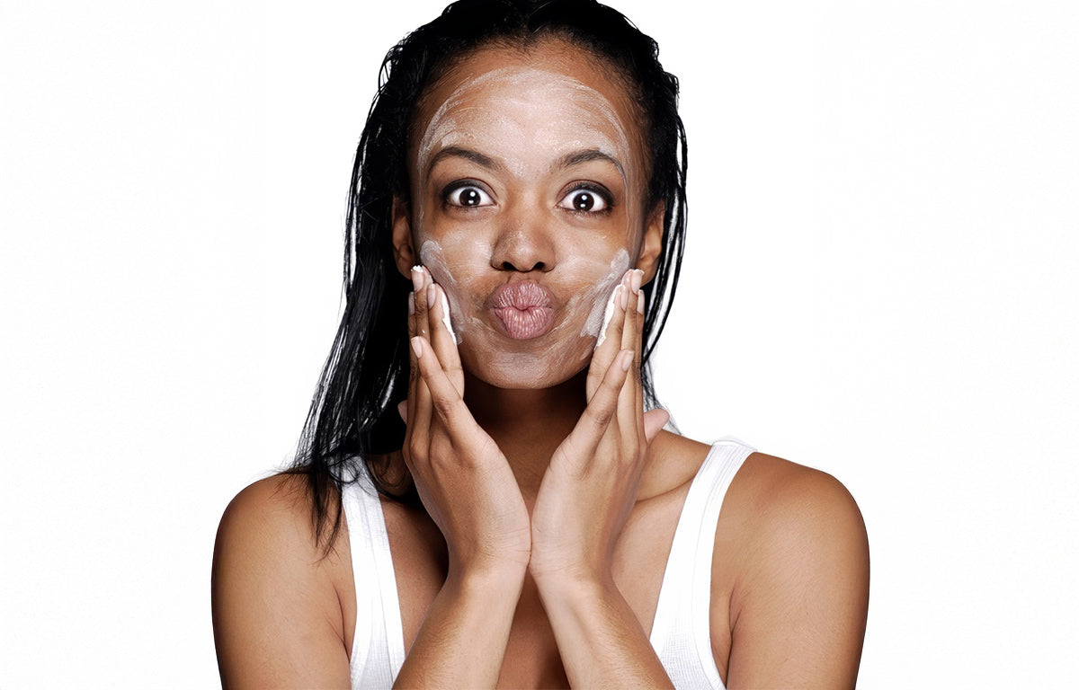 A woman washer her face with medical-grade Fix Studios GreenTea Purity™ Antioxidant Cleanser