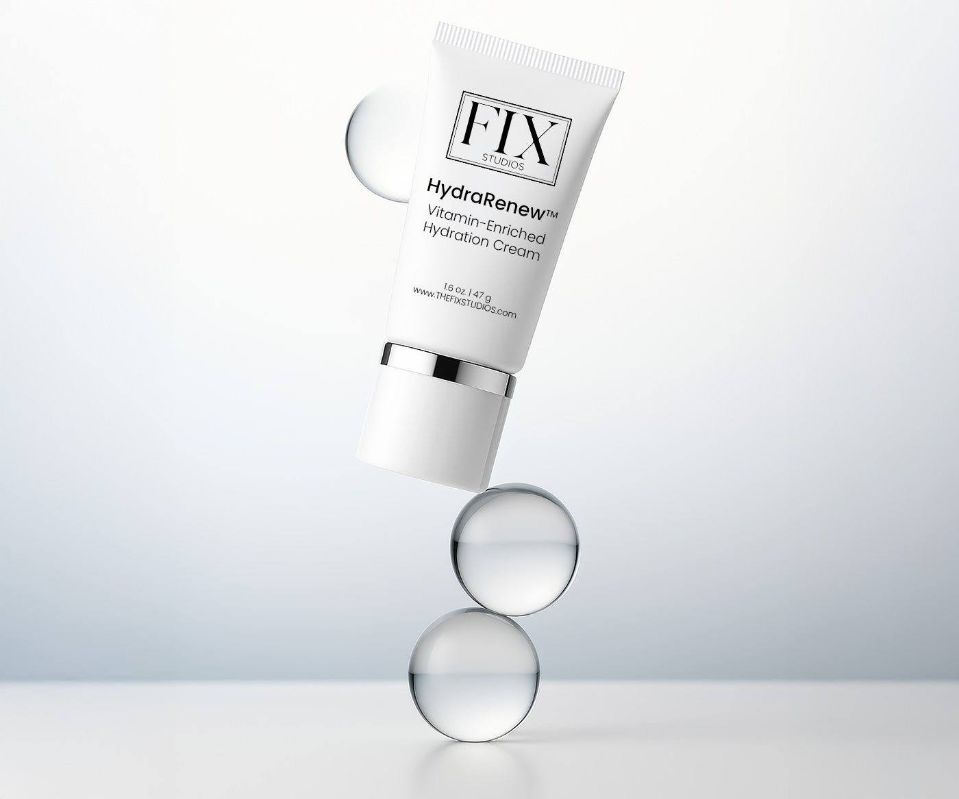 A bottle of Fix Studios medical-grade HydraRenew™ Vitamin-Enriched Hydration Cream balances on clean clear spheres