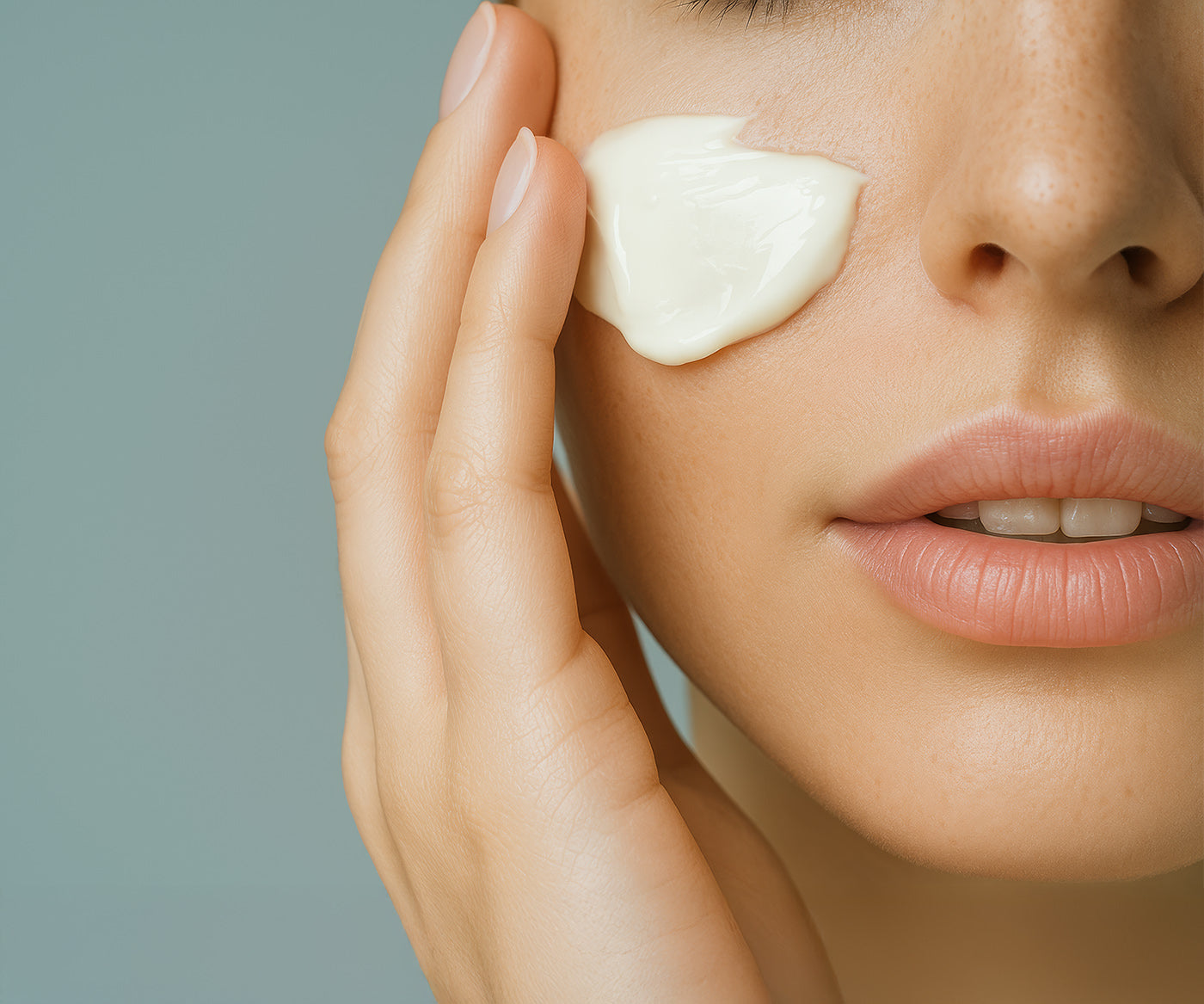 A beautiful woman applies Fix Studios medical-grade HydraSoothe™ Lightweight Soothing Moisturizer to her face
