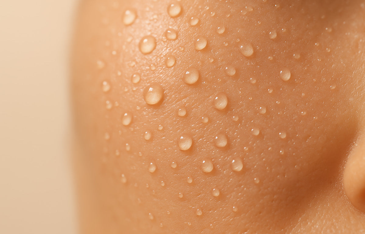 A closeup of nourished and moisturized skin with water/moisture droplets