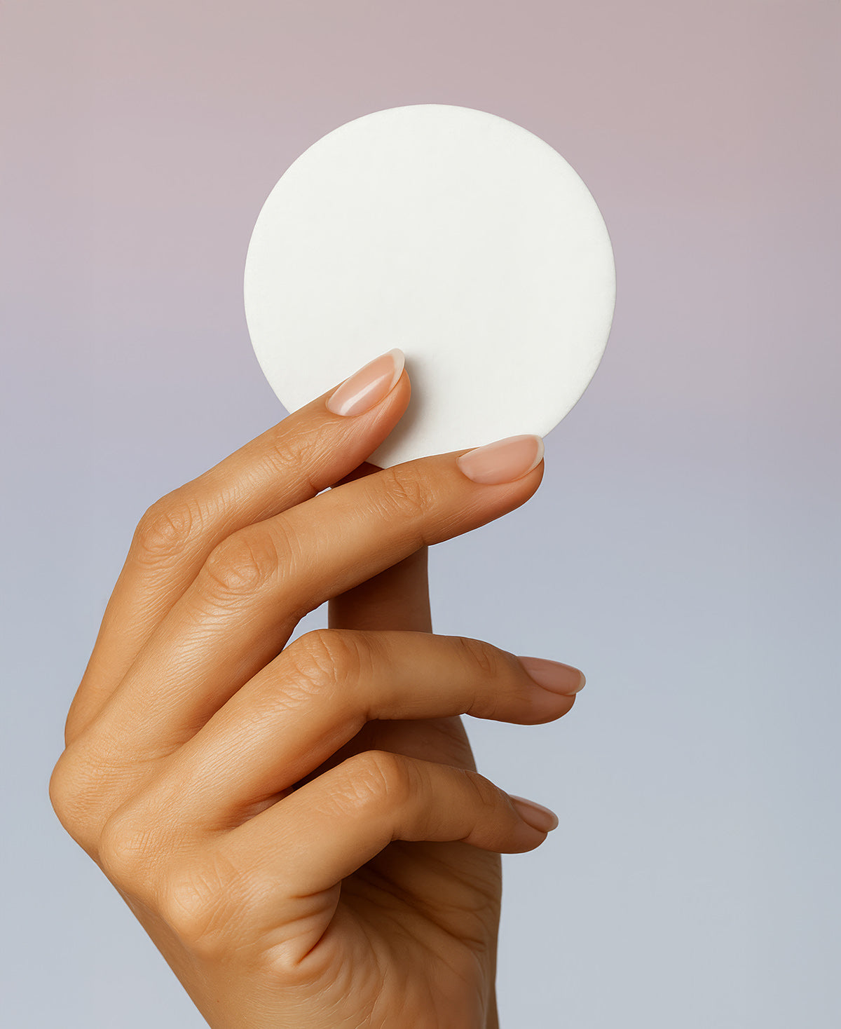 A woman's hand holding a Fix Studios PorePerfect™ Refining Cleansing Pads Medical-Grade Acne Product against a soft gradient background