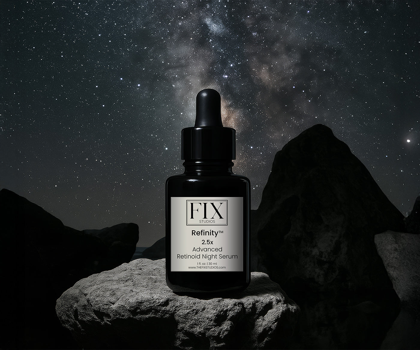 A bottle of Fix Studios medical-grade Refinity™ Advanced Retinoid Night Serum is pictured on a rock in the beautiful night sky with stars and constellations