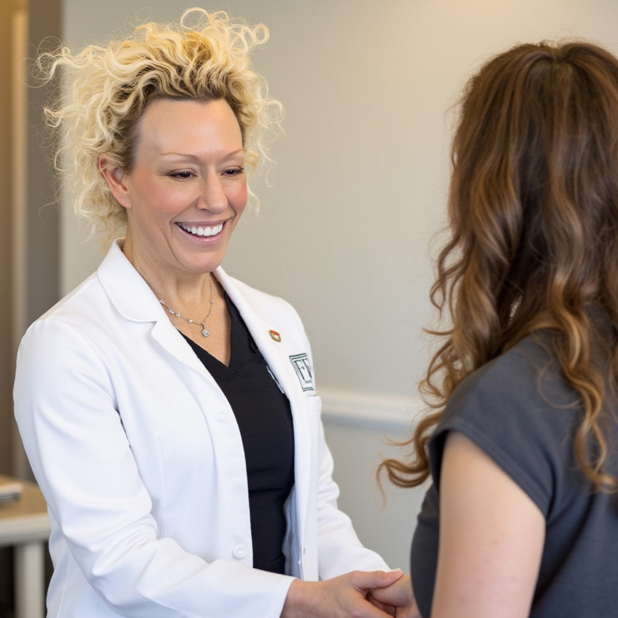 Elizabeth Matre DNP, CNP (aka Dr. Beth Matre) Greets a patient at fix studios medspa cincinnati mason OH