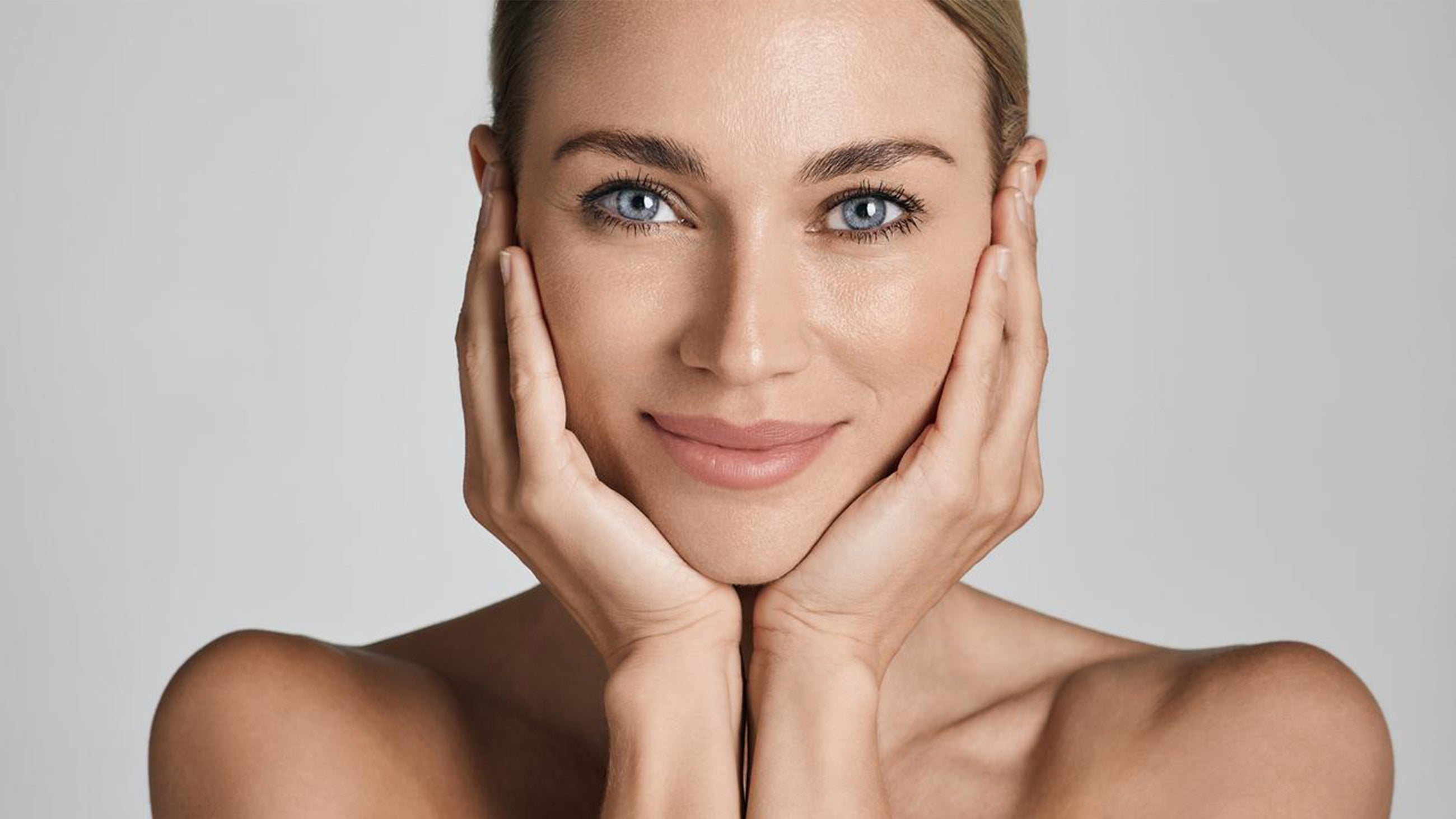 A woman maintain's her skin's glow between medspa visits