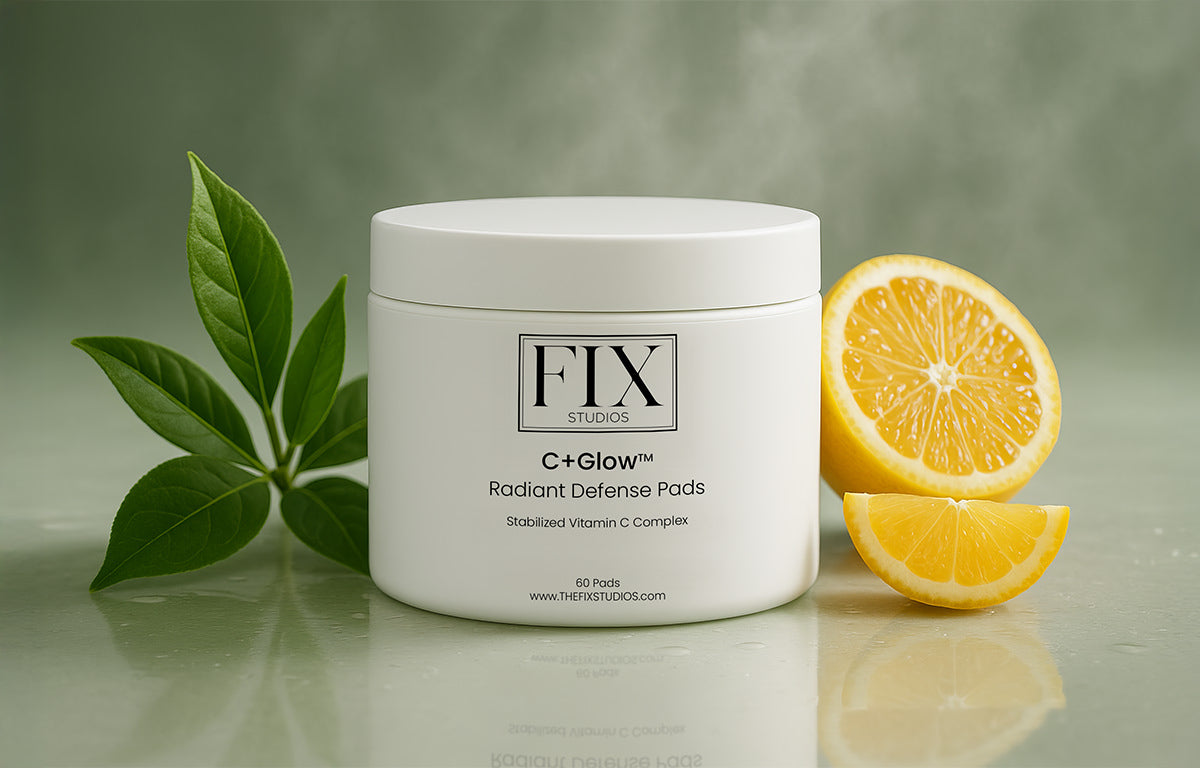 A green tea leaf and orange slice sit with Fix Studios Medical-grade C+Glow™ Radiant Defense Pads that contain antioxidant fusion blend of ingredients