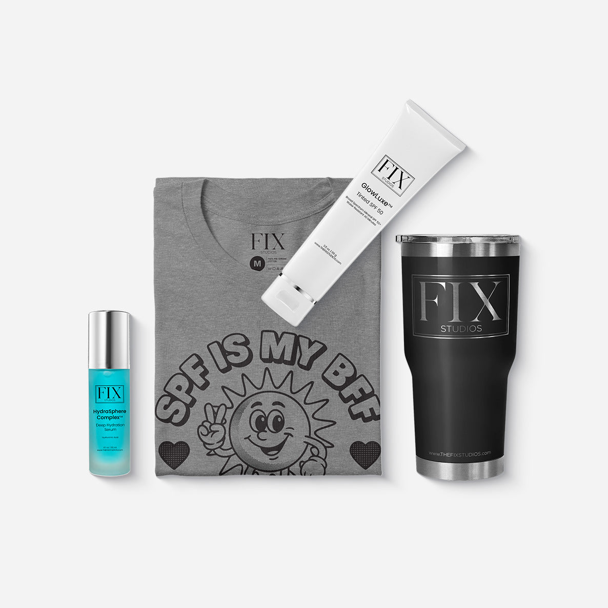 Fix Studios medical-grade skincare products, a Fix Studios stainless steel tumbler, and a Fix Studios graphic t-shirt laid flat