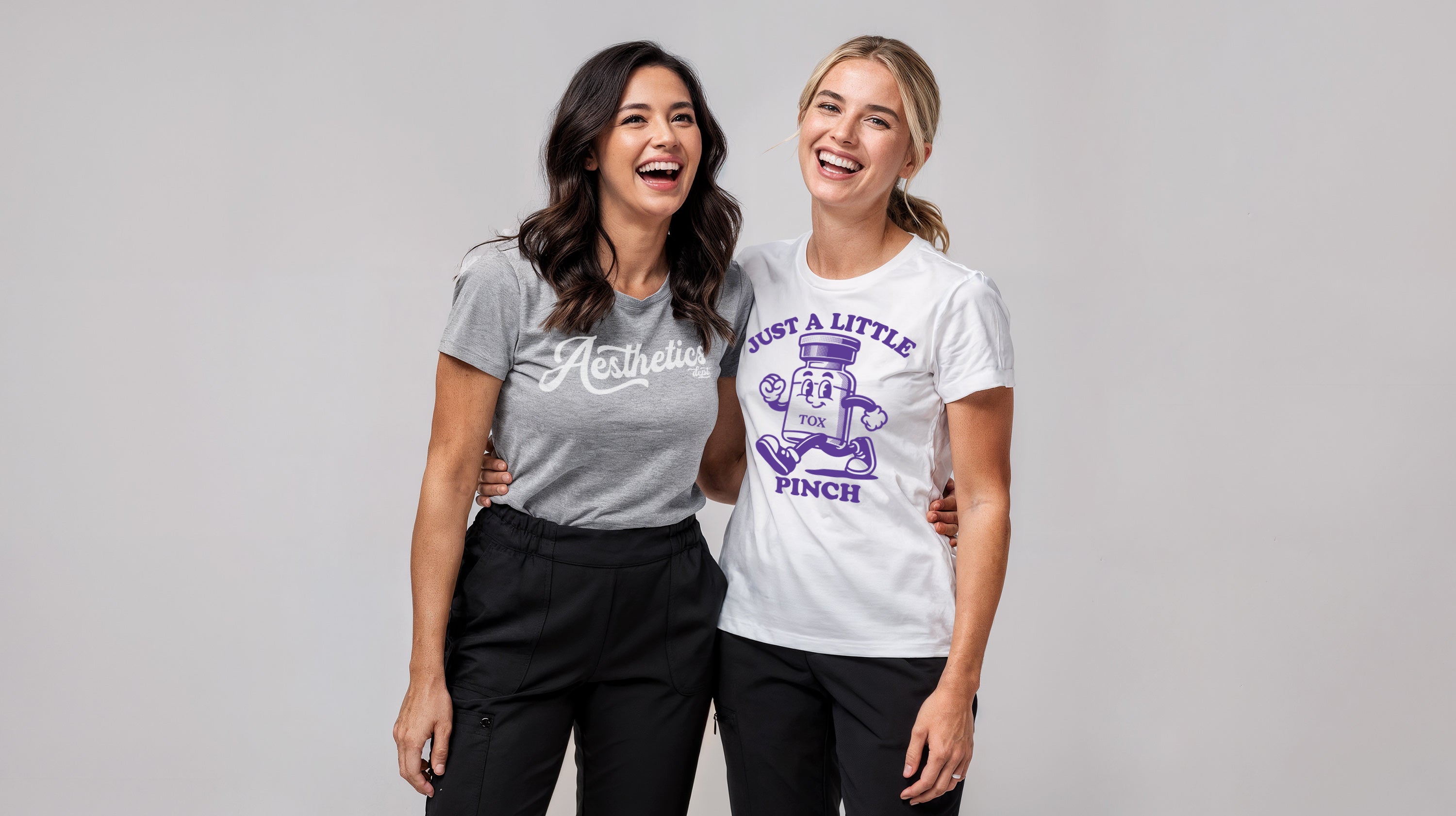 Two women wearing Fix Studios aesthetics graphic t-shirts with text and graphics on a gray background