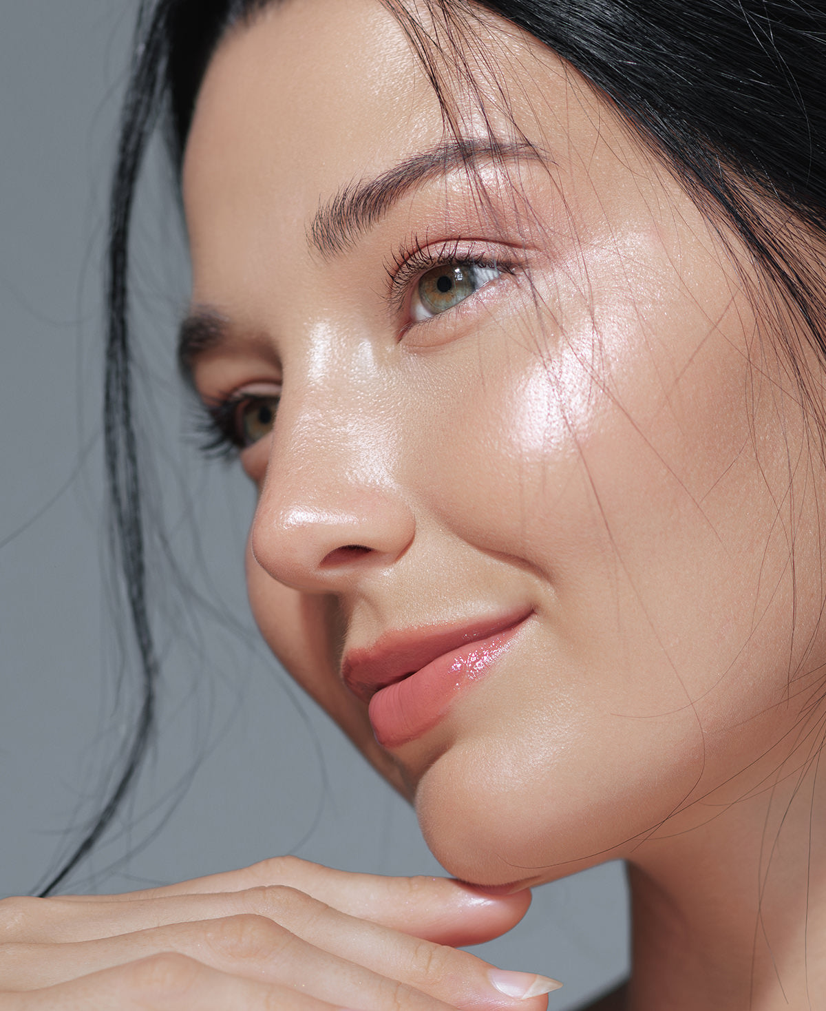 Close up of an asian woman's glowing skin after using Fix Studios medical-grade GlowLuxe™ Tinted SPF 50 sunscreen