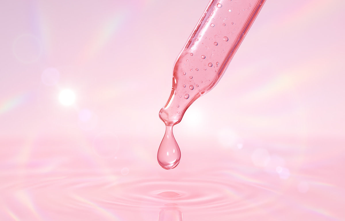 A dropper of Fix Studios medical-grade Lacera™ Lactic Radiance Serum over a pink background