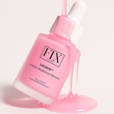 A bottle of Fix Studios medical-grade Lacera™ Lactic Radiance Serum balances while its pink serum is poured over it from above