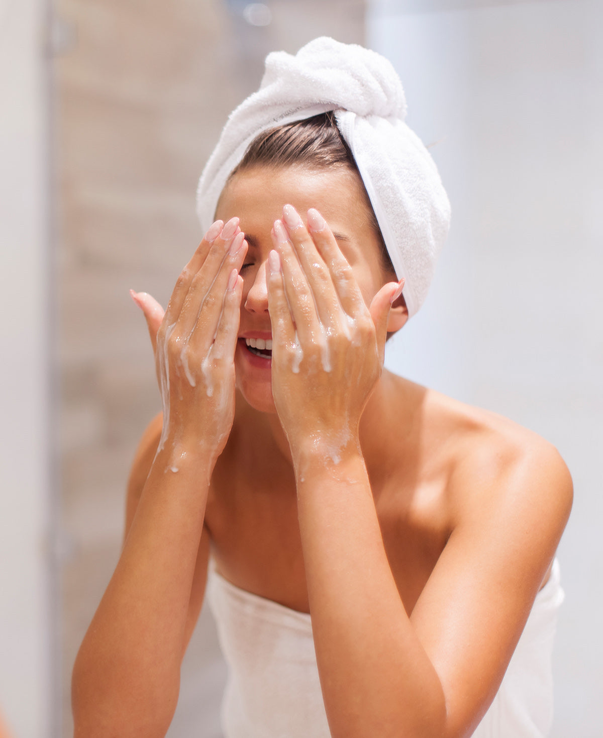 A woman washing her face with clean and clear pores after using Fix Studios medical-grade PorePerfect™ Dual-Action Detox Cleanser