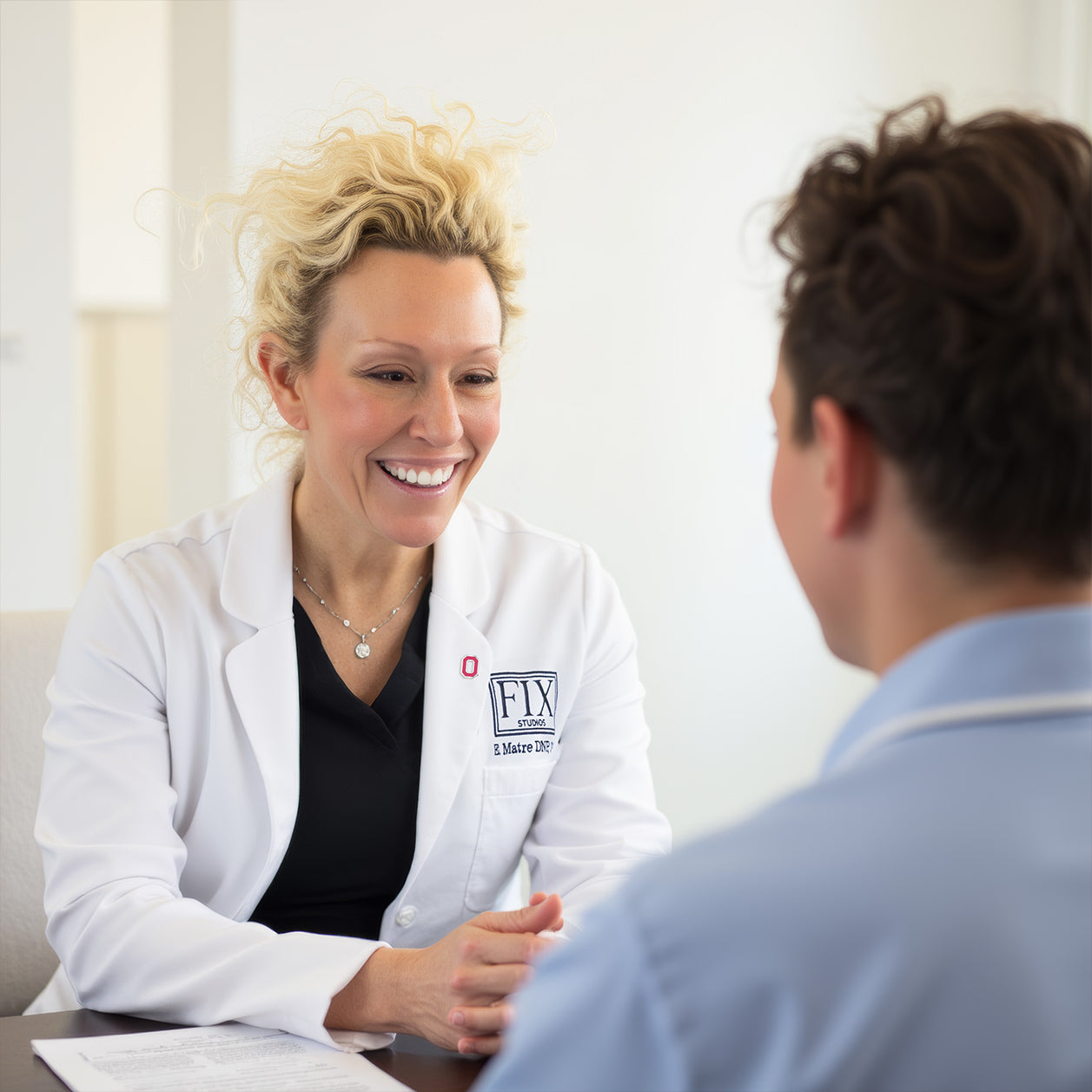 Elizabeth Matre DNP, CNP (aka Dr. Beth Matre) consults a patient