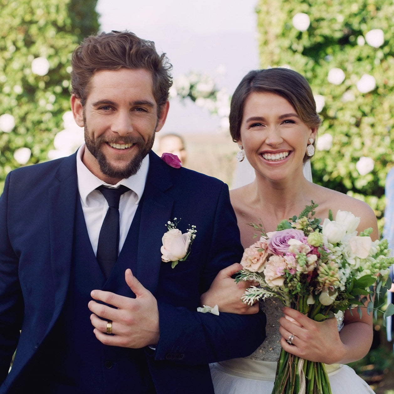 A bride and groom walk down the aisle after receiving their bridal aesthetics package from Fix Studios medspa Cincinnati Mason OH